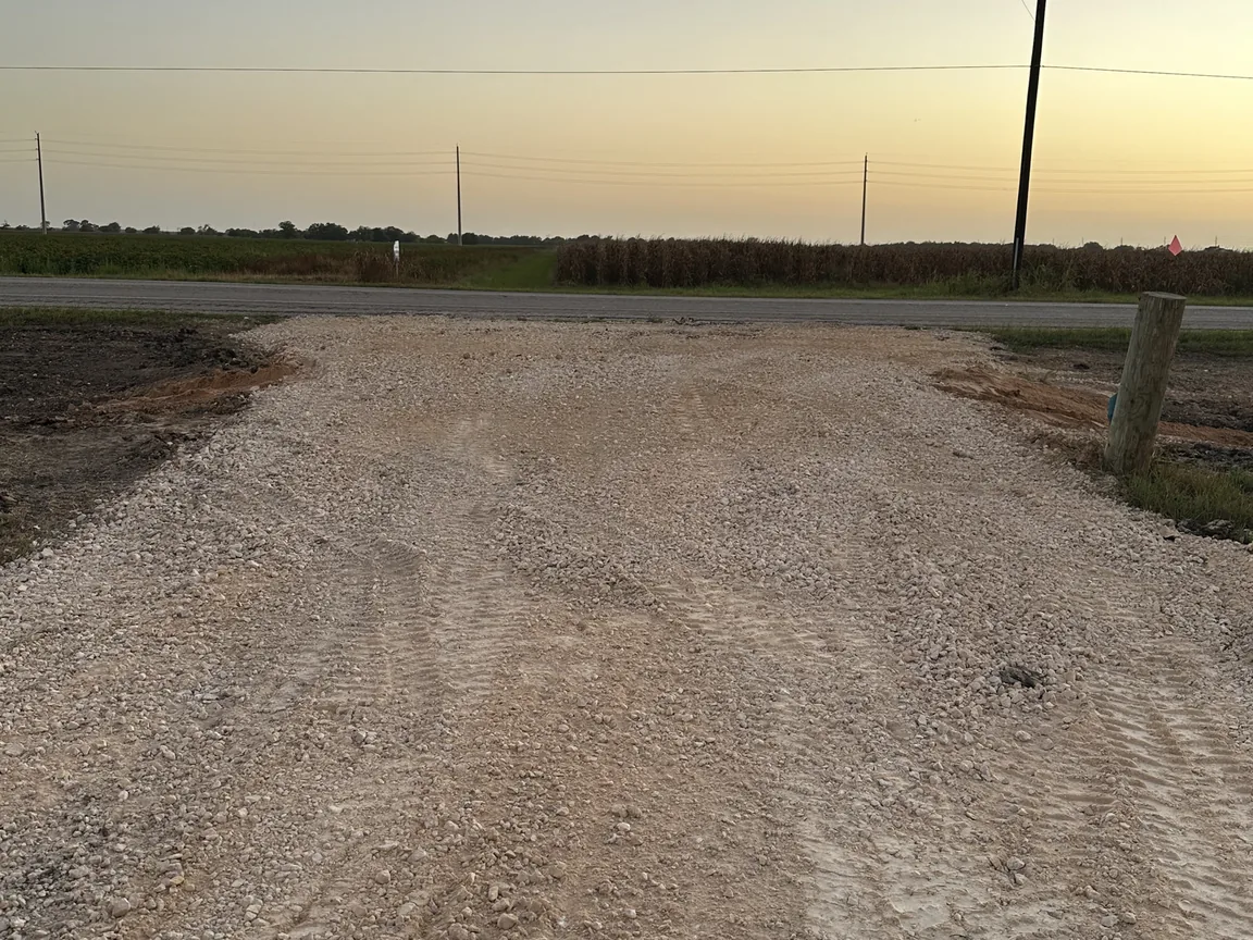 Finished gravel driveway entrance off a country road, culvert installation