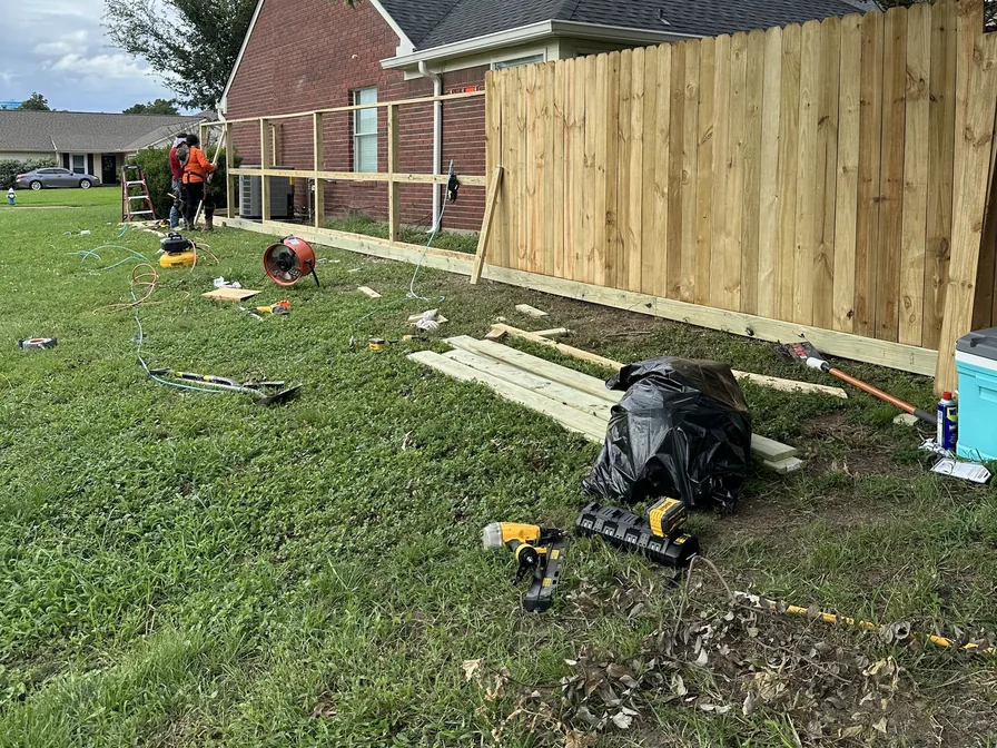 New wood privacy fence with a rot board along the bottom, privacy fence repair