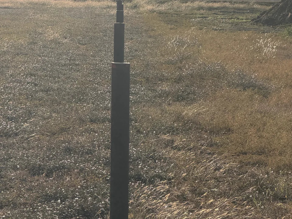 Steel pipe post driven for a new fence line, ranch fencing